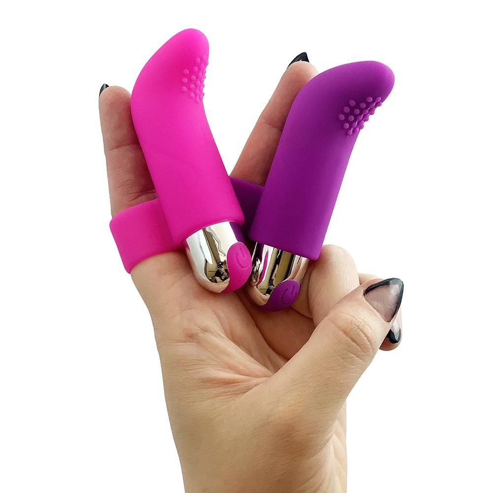 Model wearing pink and purple finger vibrators on hand