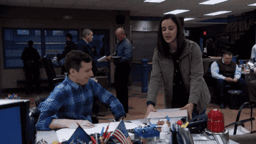Amy Santiago from brooklyn nine-nine pulling out a bunch of organized binders