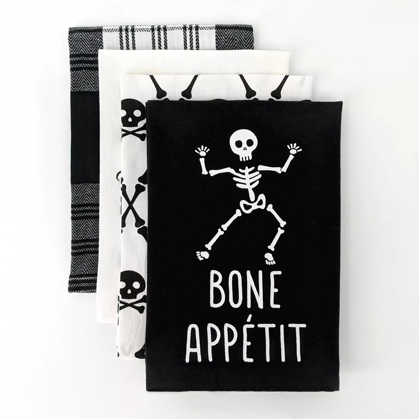 A bone appetit towel, a towel with crossbones, a white towel, and a plaid towel