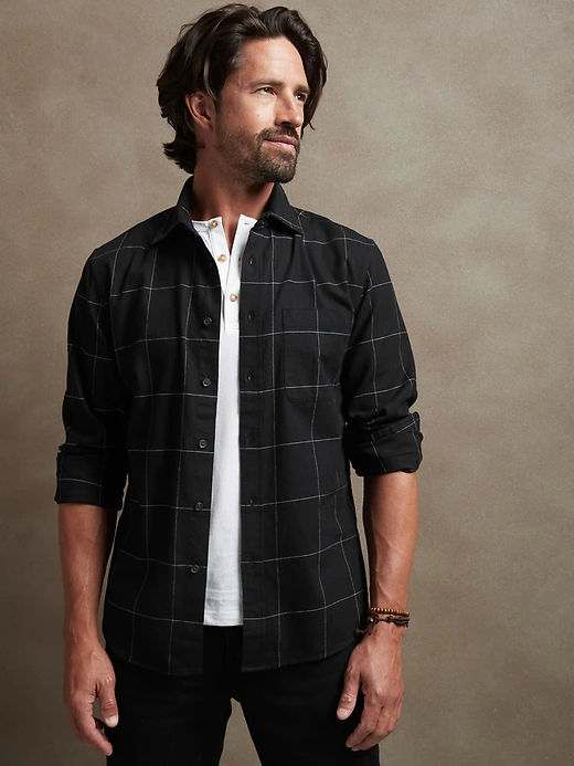 A man wearing the flannel shirt in black