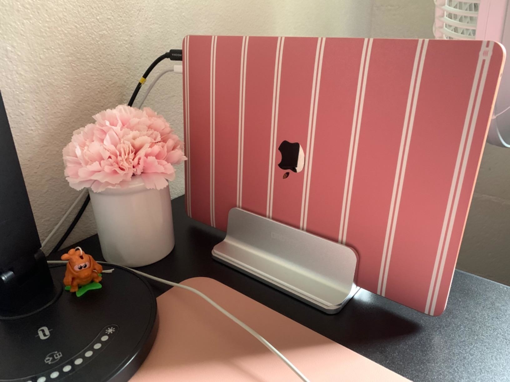 the silver stand with a MacBook in its charger