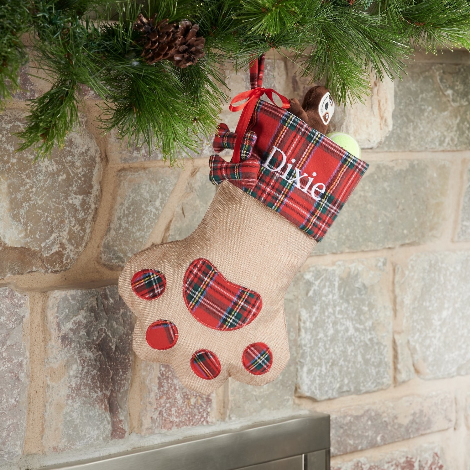 A paw-shaped stocking hanging on a mantle.