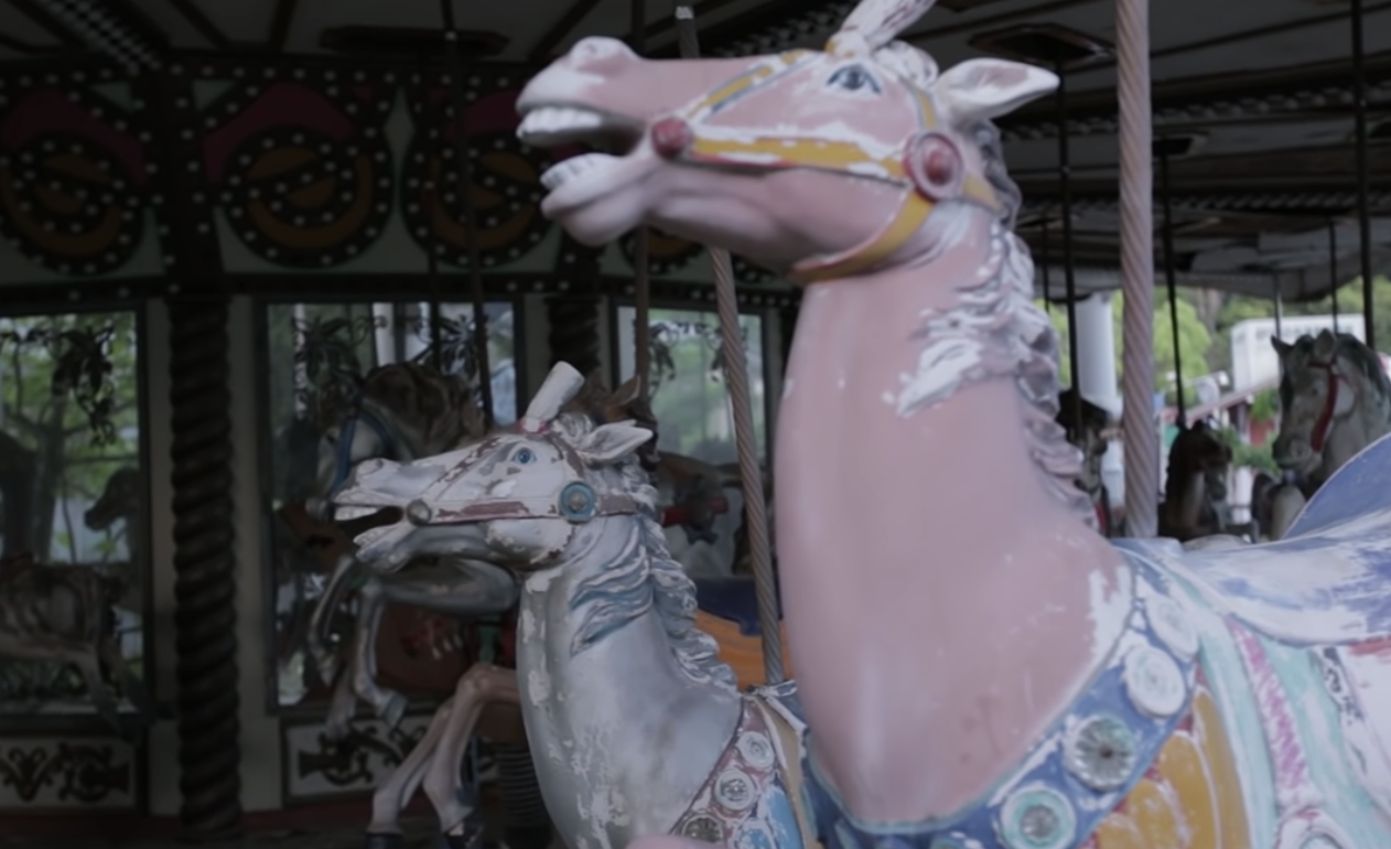 old peeled paint horses on merry-go-round