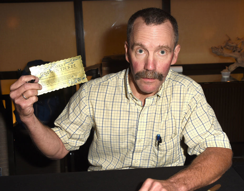 Peter Ostrum holding a golden ticket at a &quot;Willy Wonka&quot; event