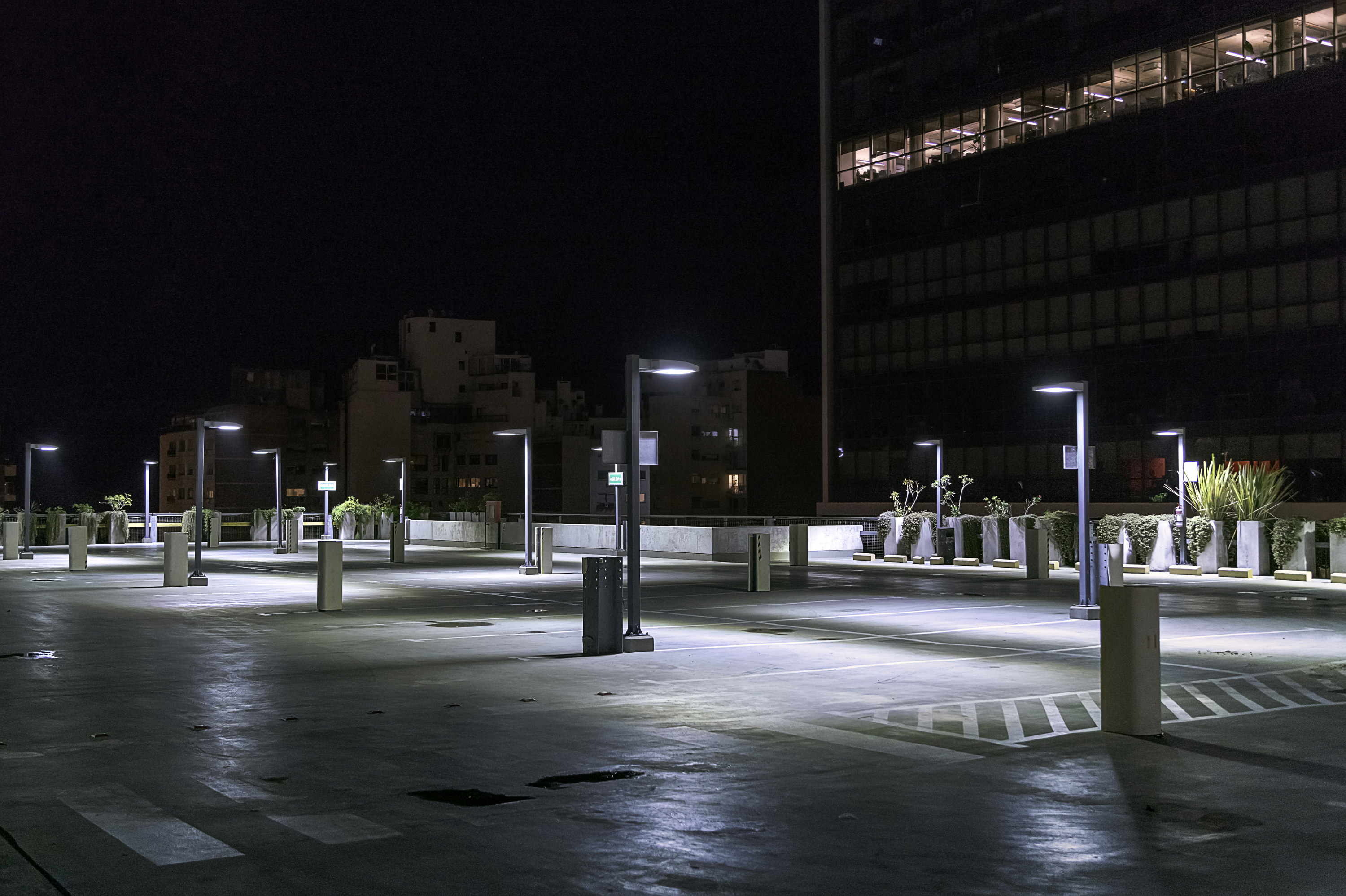 an empty parking lot at night with lights