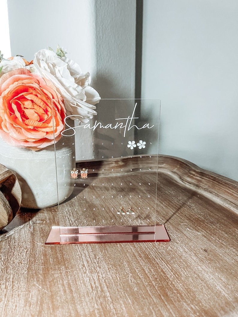 the rectangular organizer on a rose gold base with &quot;samantha&quot; written in script on top and holding stud earrings in the holes
