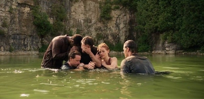 The cast sits in a dirty lake to clean themselves off and Richie begins to cry; then they all hug him