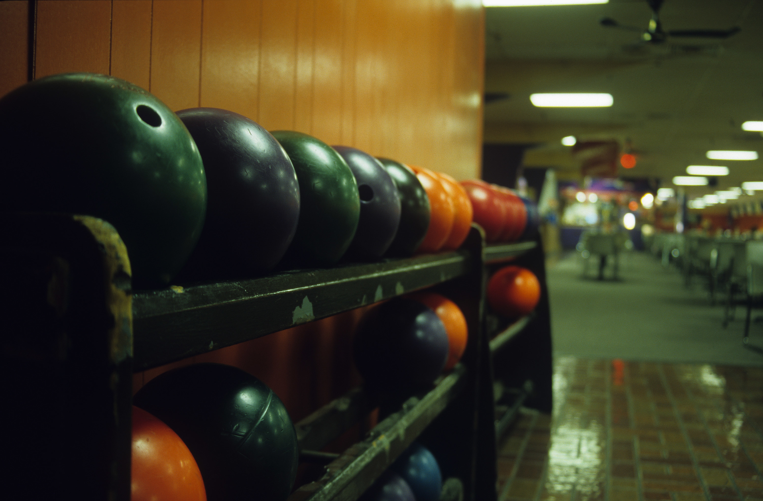bowling balls line up at a bowling alley