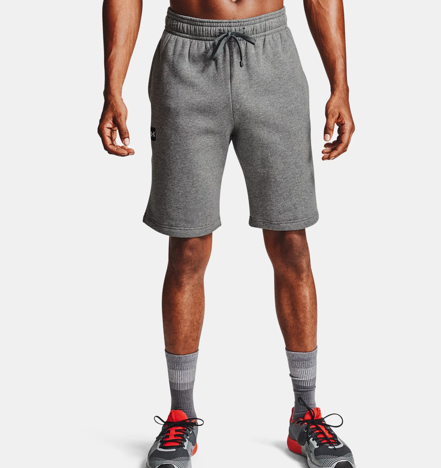 model in gray fleece workout shorts, gray socks, and gray athletic sneakers