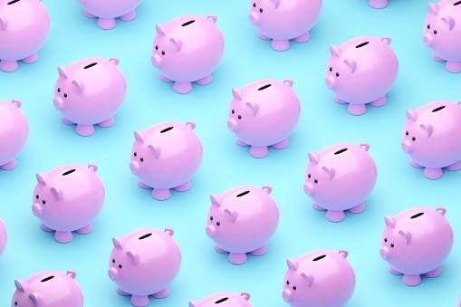Rows of piggy banks on a solid background.
