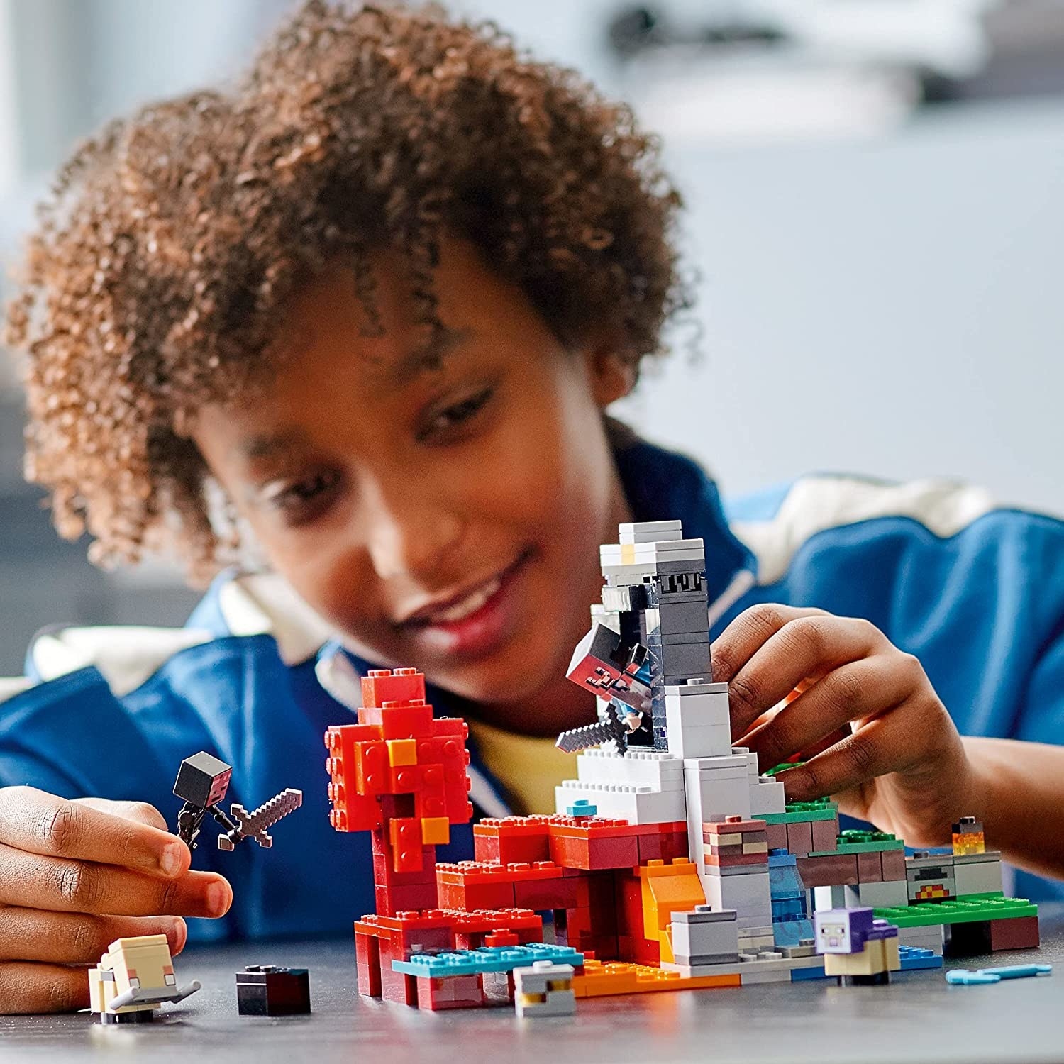 Child playing with Minecraft Lego set