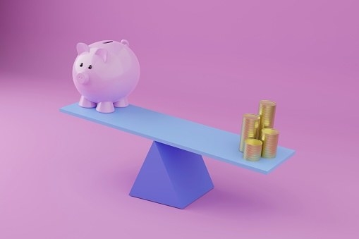 Piggy bank on a see-saw with coins on the other side