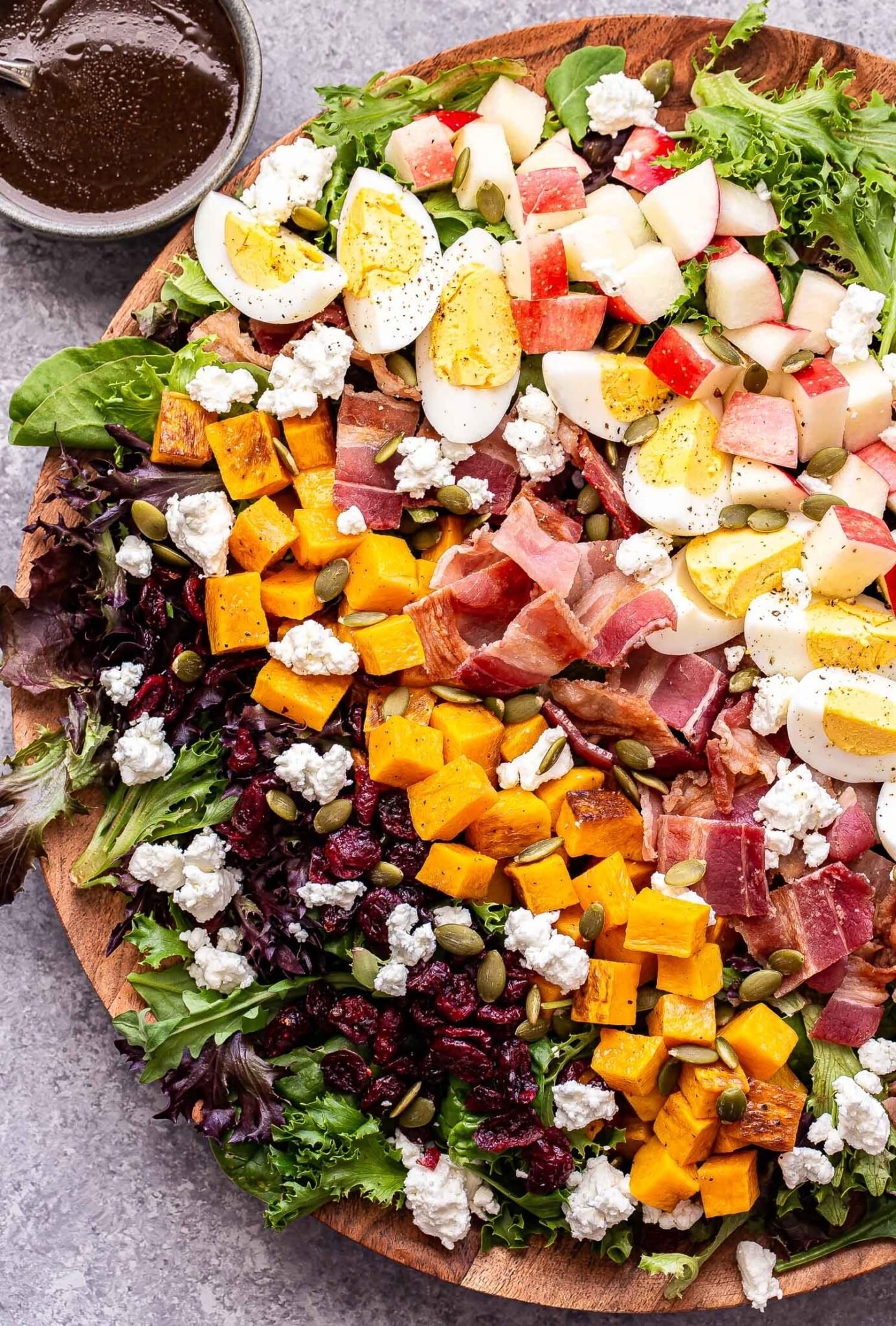 A fall cobb salad with sweet potato, bacon, craisins, apples. and more.