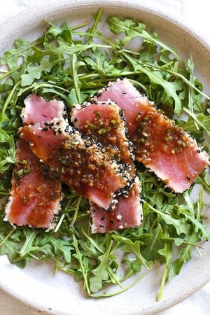 Sesame crusted seared tuna over arugula.