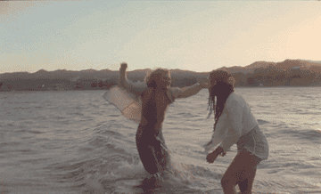 Hayley Kiyoko hugs Alexandra Shipp in the water in her music video &quot;Chance&quot;
