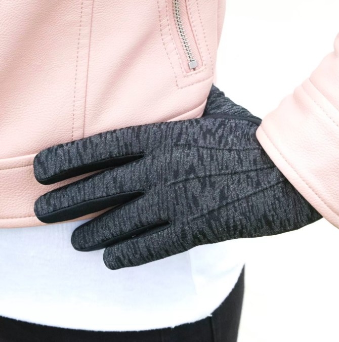 Close-up of a model wearing the glove while placing their hand on their hip