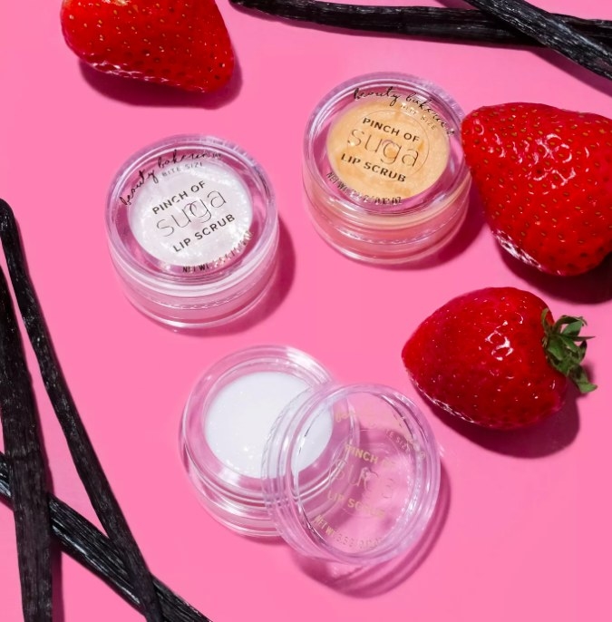 Three mini containers of the lip scrub with strawberries