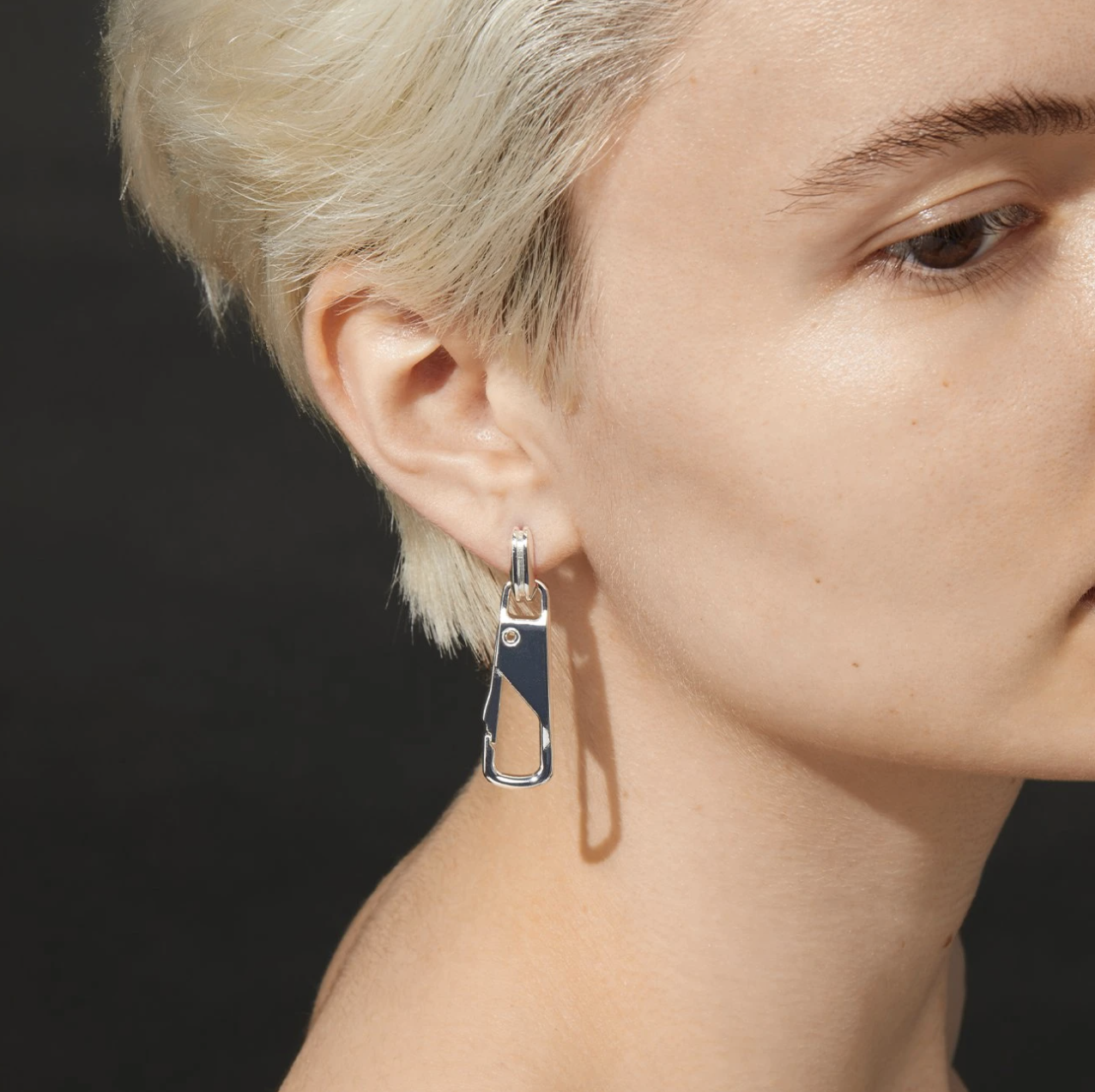 a profile photo of a person wearing the convertible earrings with the big clip attached