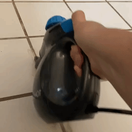 reviewer GIF using steam cleaner to clean tile grout