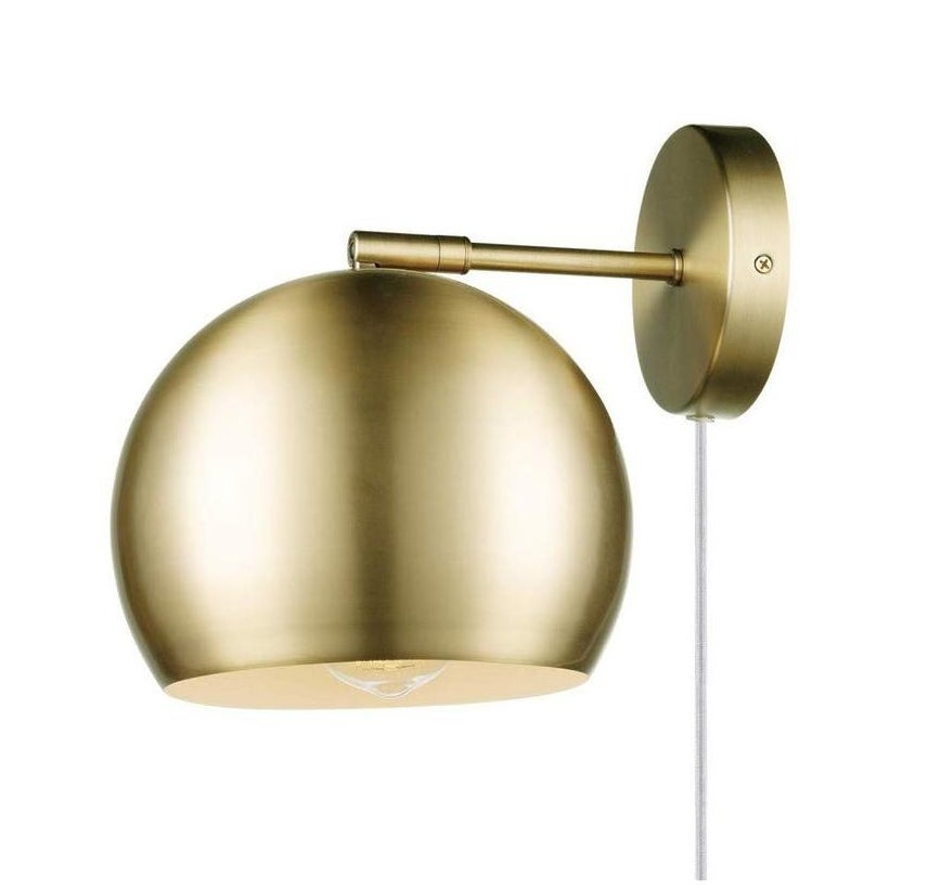 The round wall sconce in a brushed gold finish