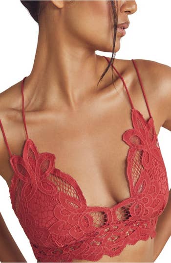 Model wearing red lace Free People bralette, front