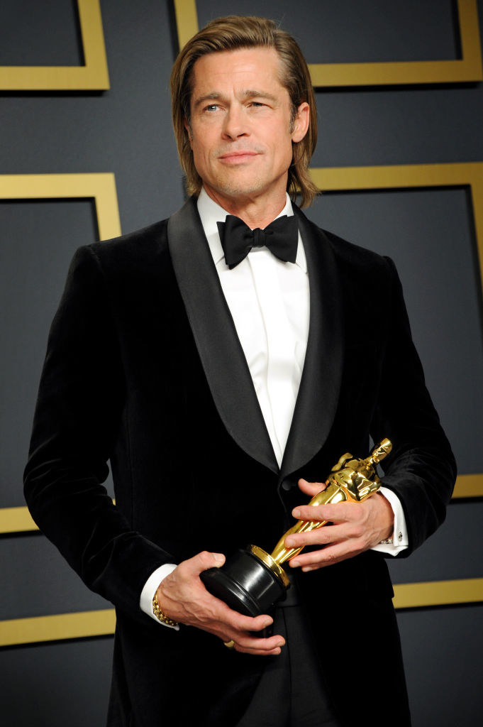 Brad holding his Oscar at the academy awards