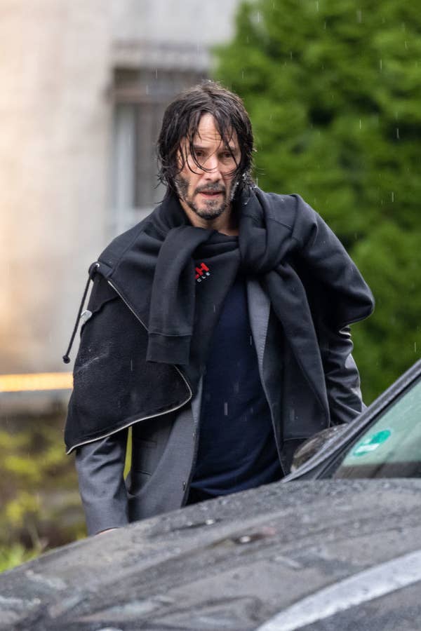 Keanu, with a beard, filming john wick in the rain