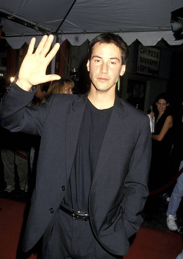 Keanu waving to the crowd at the premiere of the movie Speed sexiest man alive