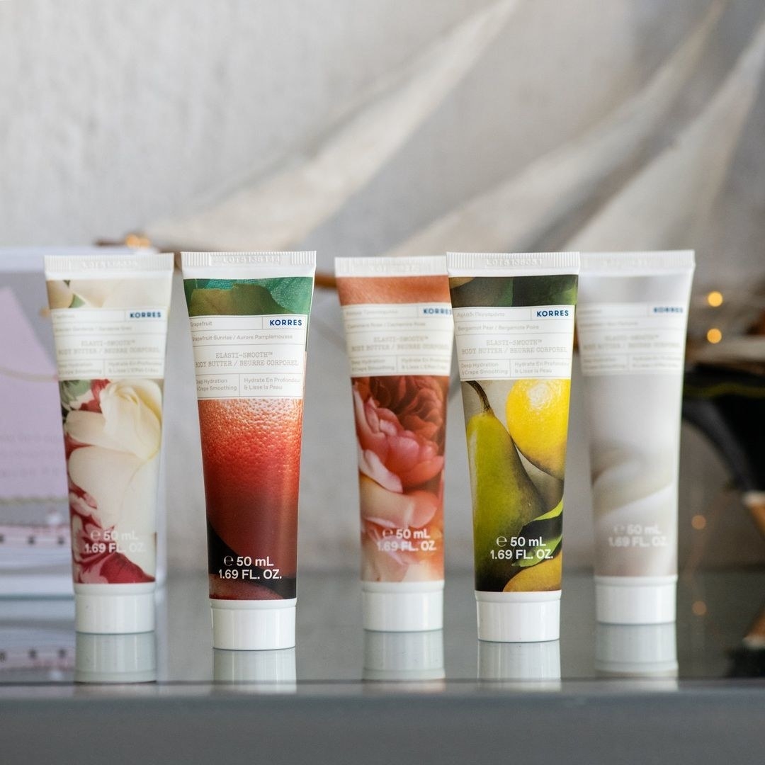 the five-piece set of body lotions arranged neatly on a glossy countertop