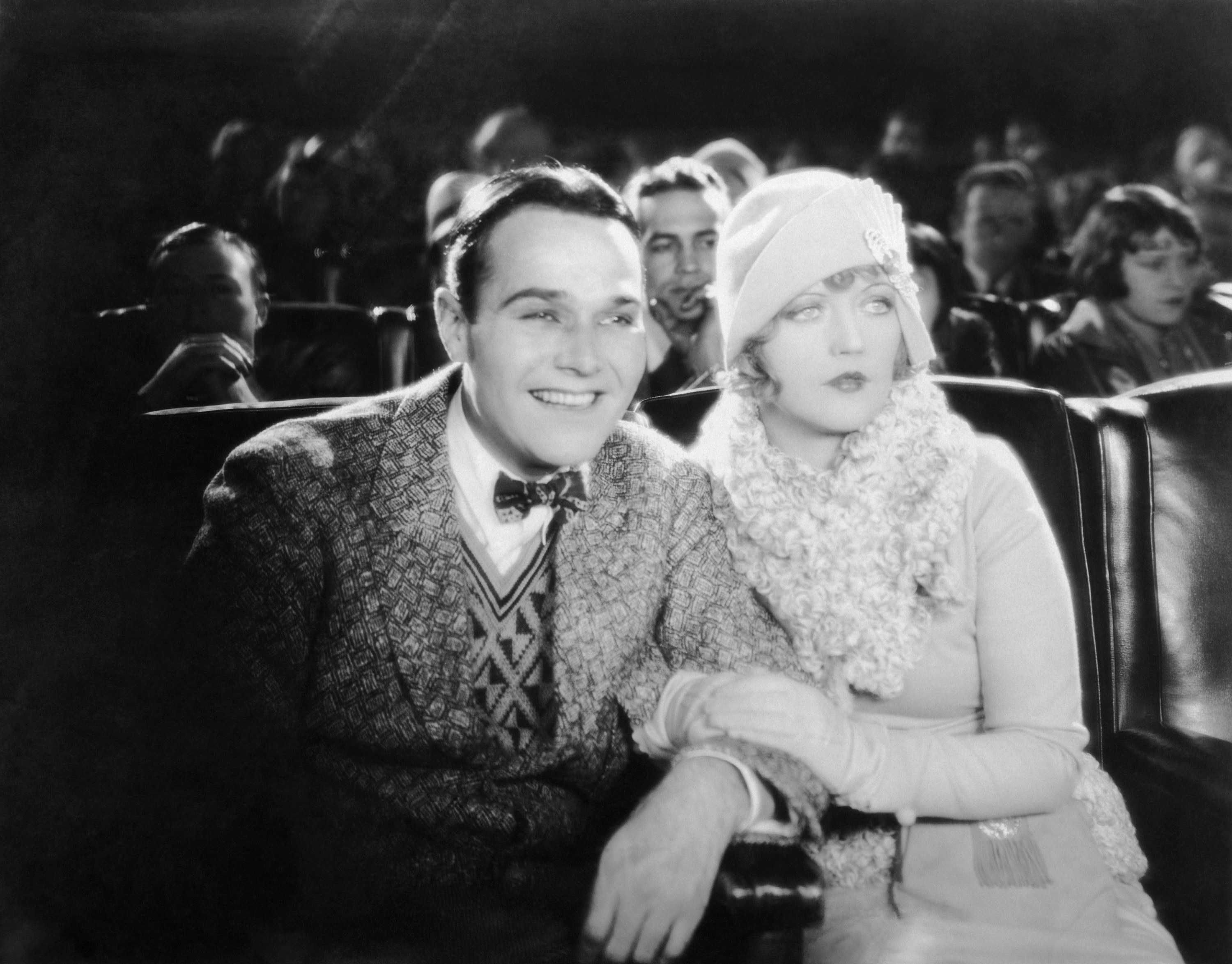 Billy Haines and a woman in a movie theater