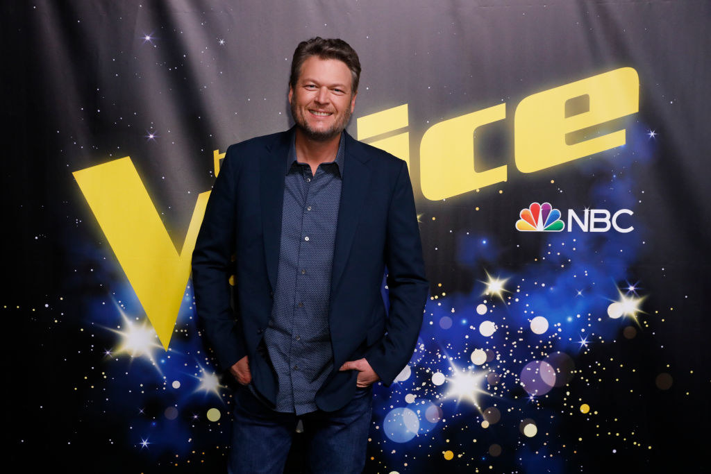 Blake with his hands in his pocket as he poses at a Voice event