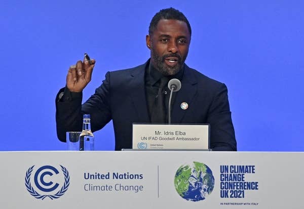 Idris at a podium giving a speech at the UN Climate Change Conference