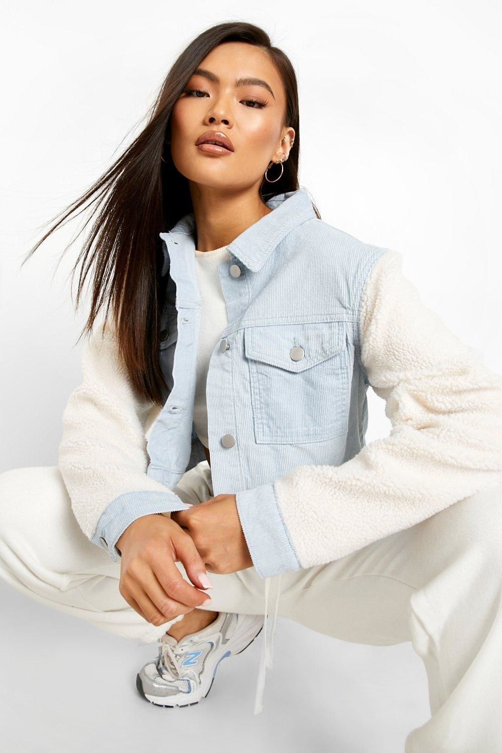 model in light blue corduroy jacket with fuzzy sleeves