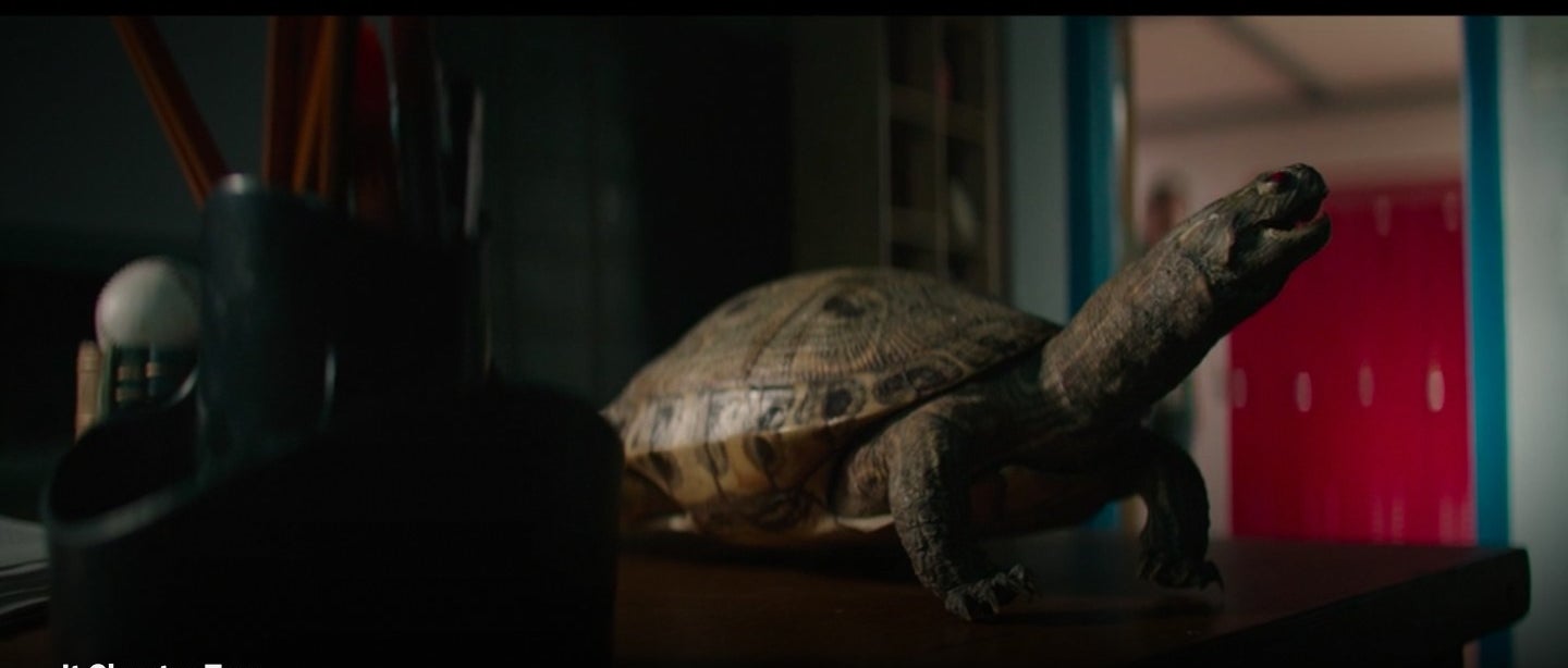 A turtle statue sitting on a desk in "It: Chapter Two"