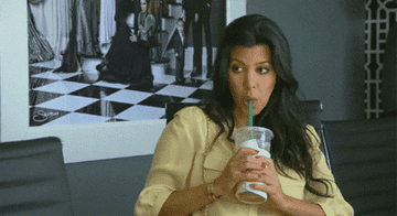 Kourtney Kardashian sipping on an iced coffee.