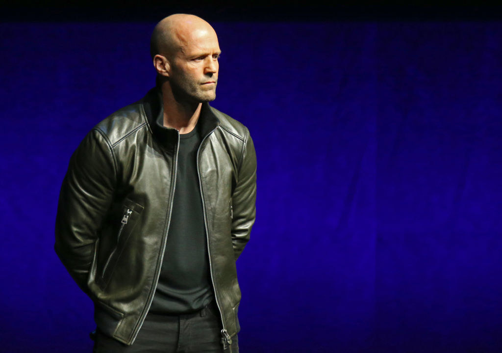 Statham speaking during an event