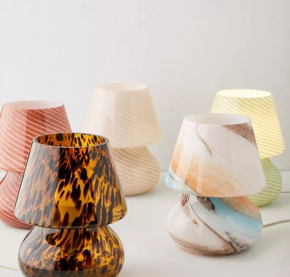 several glass lamps with glass lampshades, all in different colors