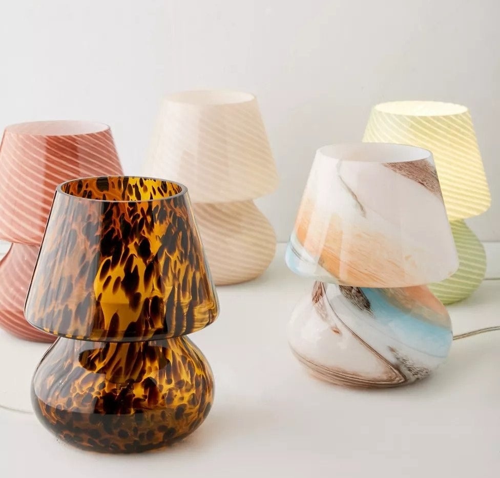 several glass lamps with glass lampshades, all in different colors