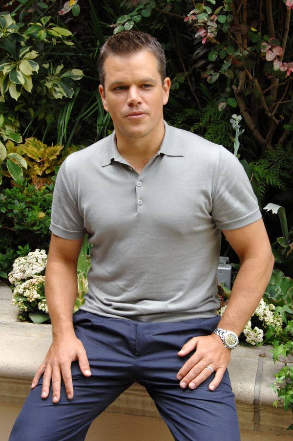 Matt sitting on a bench at the bourne ultimatum presser sexiest man alive