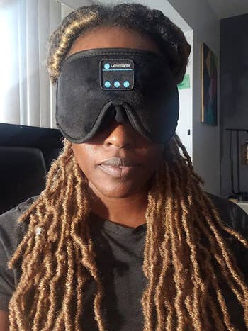 a reviewer wearing the sleep mask