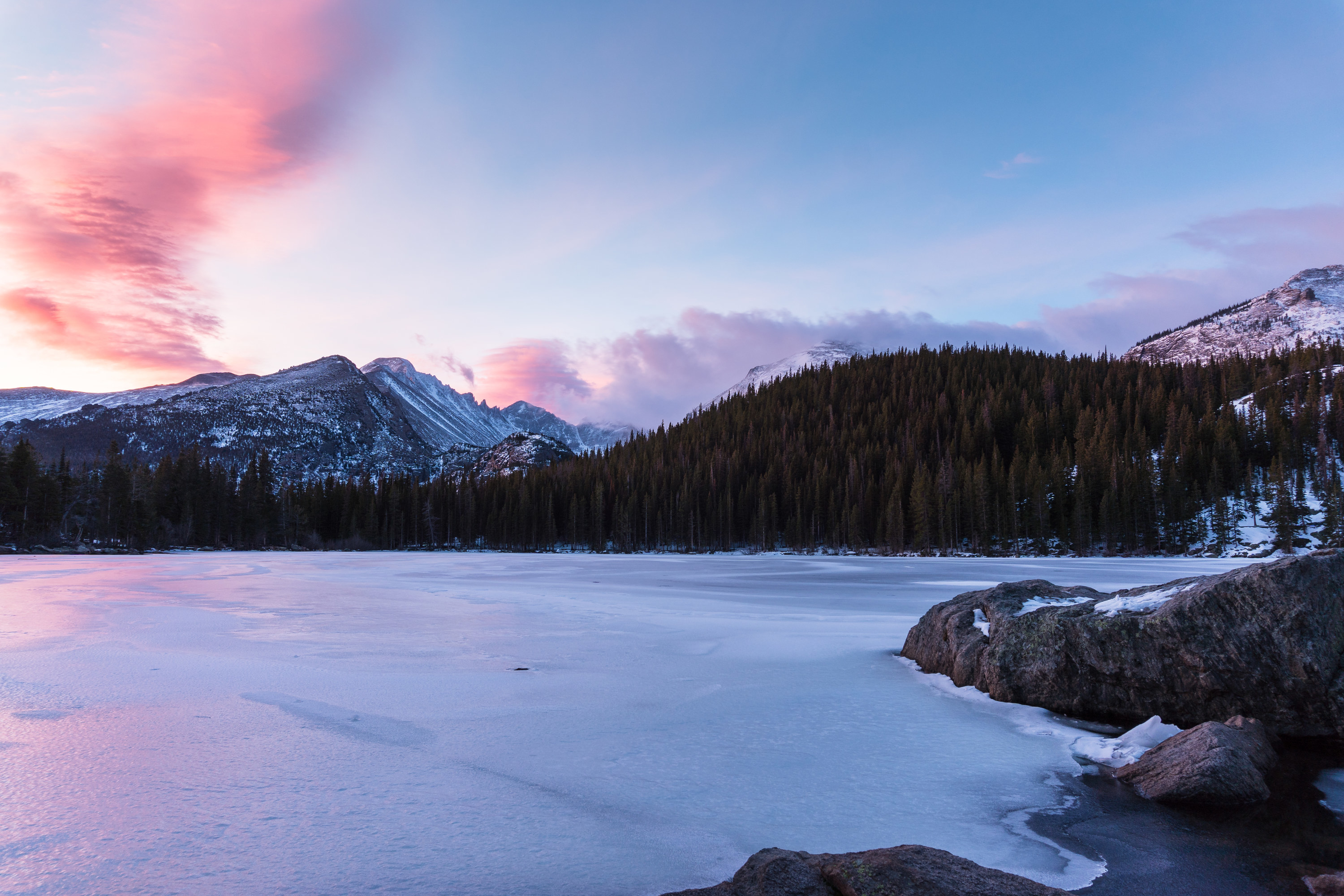 Winter sunrise at Bear Lake in Rocky Mountain National Park with the lake frozen