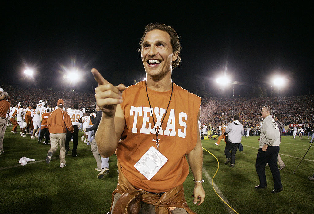 Matthew wearing a Texas Longhorns shirt on the football field