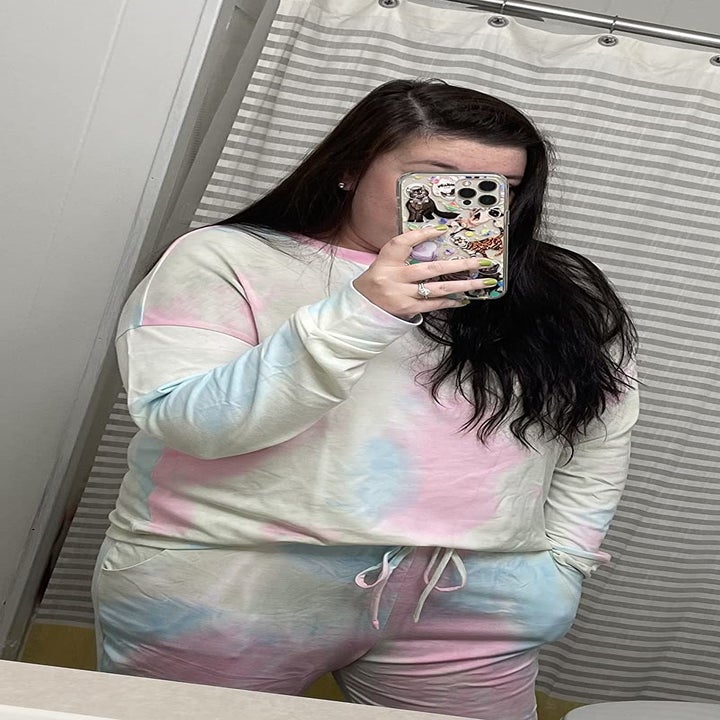 a reviewer in the same set and taking a mirror selfie