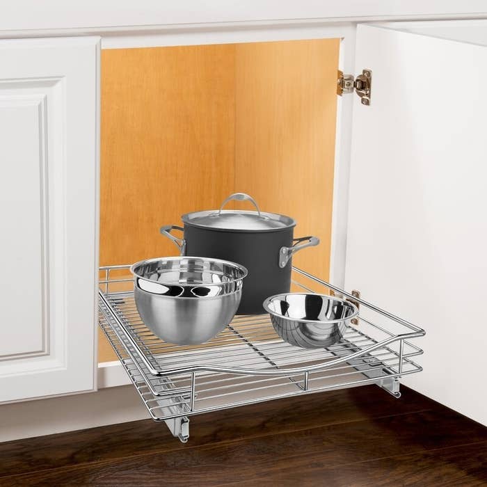 Pull out drawer with a few pots and pans on it