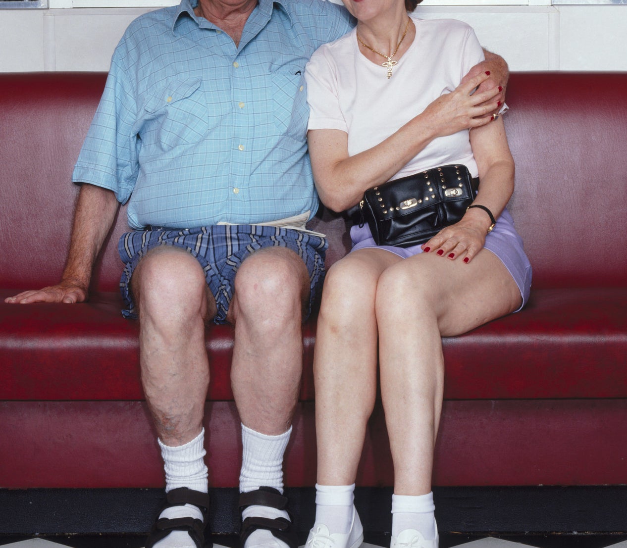 An older couple wearing high white socks.