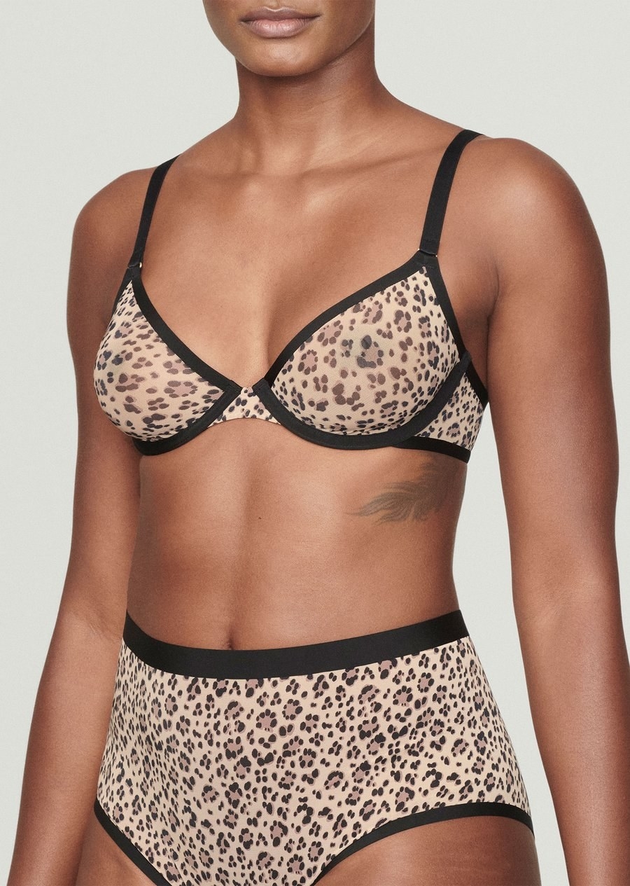 Model wearing unlined cheetah print bra and panty set
