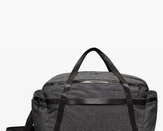 The gray duffle bag with black straps