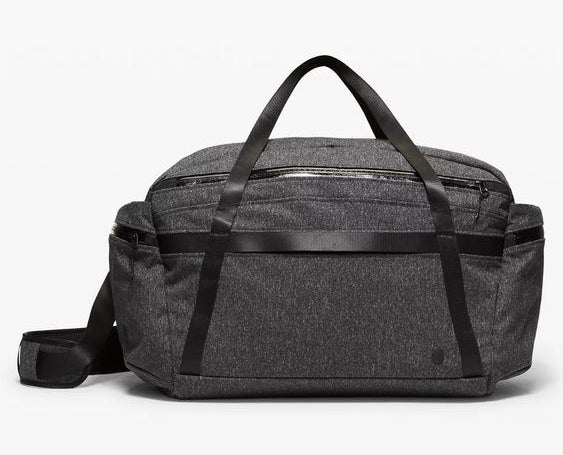 The gray duffle bag with black straps