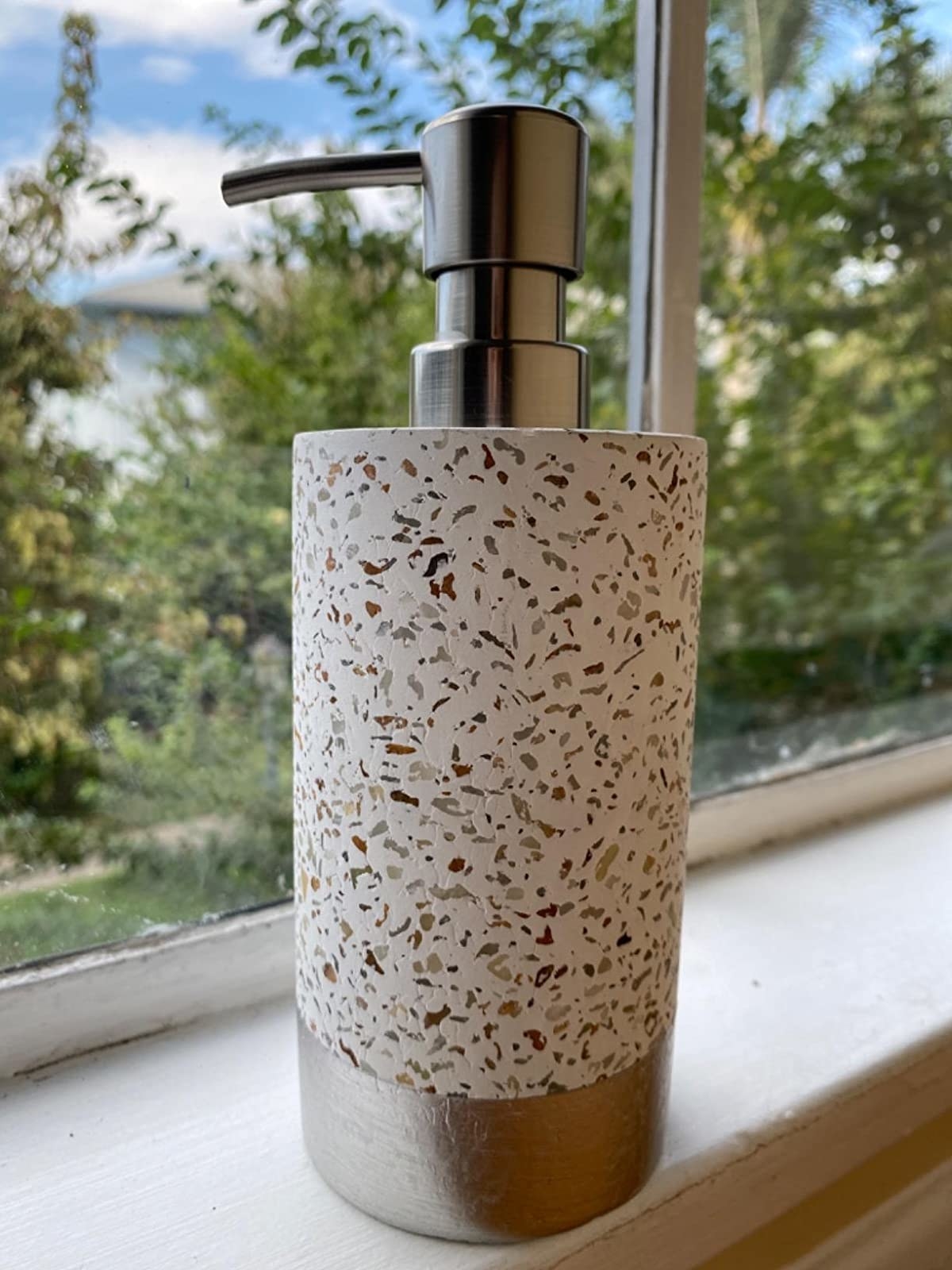 Reviewer photo of the soap dispenser on a window sill
