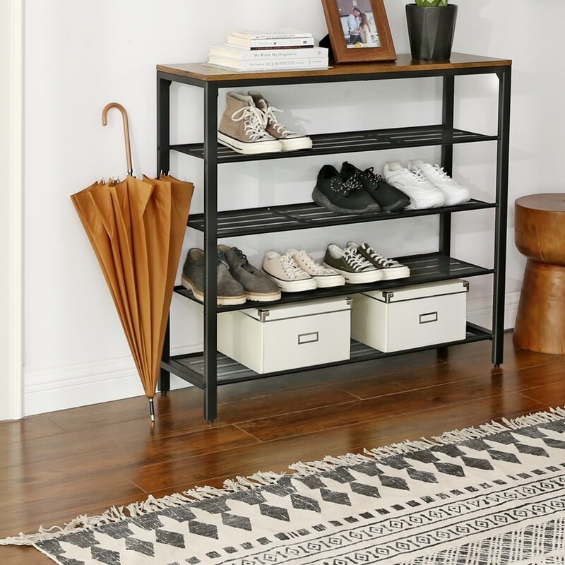 Five-tier storage shelf with shoes and other assorted items on it